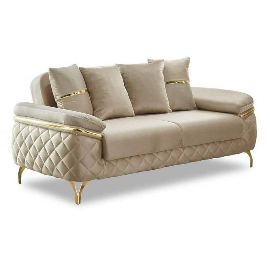 Beige tufted sofa with gold accents